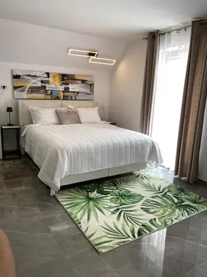 a bedroom with a bed with a green leaf rug at Lux in Bohinj in Bohinj