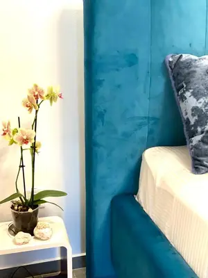 a table with a plant on it next to a bed at Lux in Bohinj in Bohinj