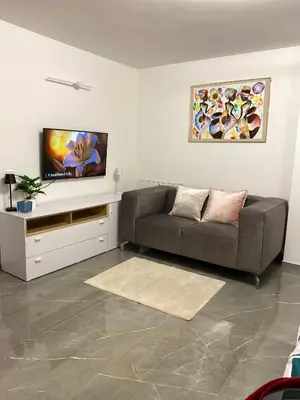a living room with a couch and a flat screen tv at Lux in Bohinj in Bohinj