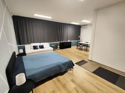 a room with a bed and a large screen at Sleep&Go Vrtojba International Border Crossing in Šempeter pri Gorici