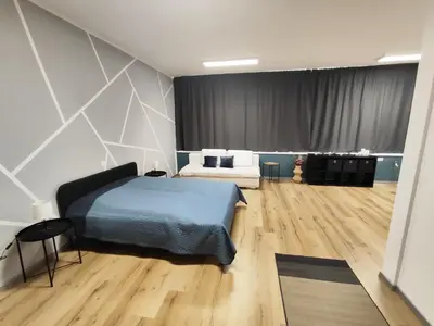 a bedroom with a bed and a couch in a room at Sleep&Go Vrtojba International Border Crossing in Šempeter pri Gorici