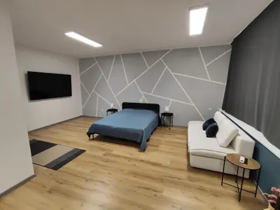 a bedroom with a bed and a couch at Sleep&Go Vrtojba International Border Crossing in Šempeter pri Gorici