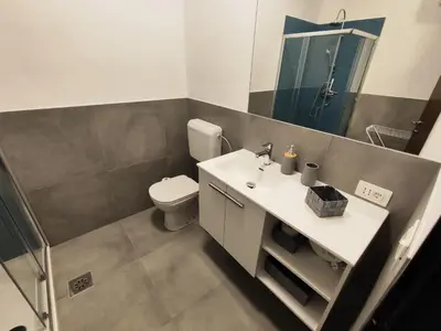 a bathroom with a toilet and a sink and a mirror at Sleep&Go Vrtojba International Border Crossing in Šempeter pri Gorici