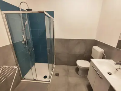 a bathroom with a shower and a toilet and a sink at Sleep&Go Vrtojba International Border Crossing in Šempeter pri Gorici