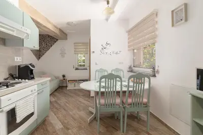 a kitchen with a table and chairs in a room at Apartma Bohinj in Bohinj