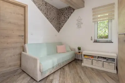 a living room with a couch and a window at Apartma Bohinj in Bohinj