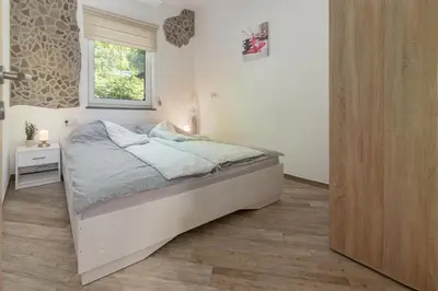 a bedroom with a bed in a room with a window at Apartma Bohinj in Bohinj