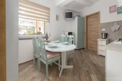 a kitchen and dining room with a table and chairs at Apartma Bohinj in Bohinj