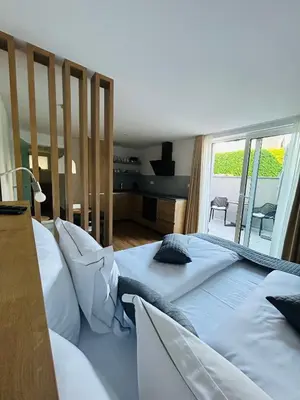 a bedroom with two beds and a large window at Apartma Neja in Žirovnica
