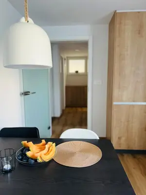 a black table with a plate of food on it at Apartma Neja in Žirovnica