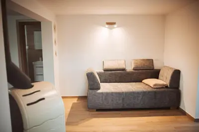 a living room with a couch in the corner at Holiday Home Vinagora in Bistrica ob Sotli