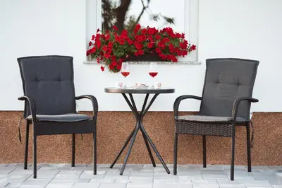 two chairs and a table with two glasses of wine at Holiday Home Vinagora in Bistrica ob Sotli