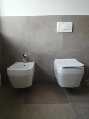 a bathroom with a white toilet and a bidet at Silentium Domus doo in Gornje Vreme