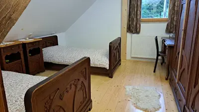 a bedroom with two beds and a desk and a window at Pr Trnovc in Preddvor