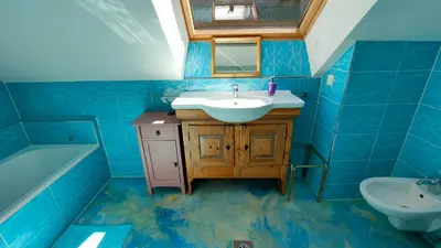 a blue bathroom with a sink and a mirror at Pr Trnovc in Preddvor