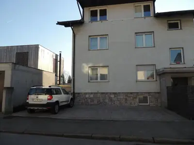 a white car parked in front of a building at Your Ljubljana Home in Ljubljana