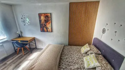a small bedroom with a bed and a desk at Simona's place-Free private parking in Ljubljana