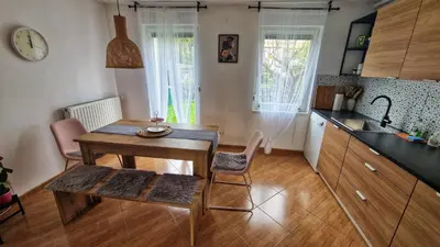 a kitchen with a table and chairs and a sink at Simona's place-Free private parking in Ljubljana