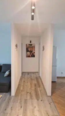 a living room with a couch and a painting on the wall at Simona's place-Free private parking in Ljubljana