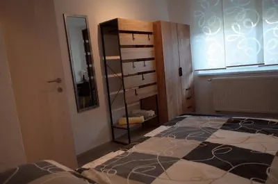 a bedroom with a bed and a mirror and a closet at Simona's place-Free private parking in Ljubljana