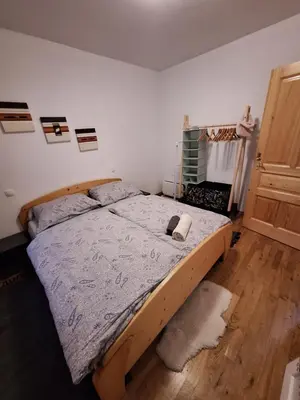 a bedroom with a bed with a wooden frame at Sunrise Apartment in Rateče