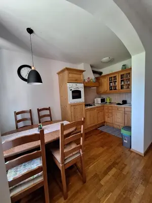 a kitchen with a table and chairs in a room at Sunrise Apartment in Rateče