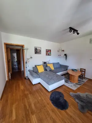 a living room with a couch and a table at Sunrise Apartment in Rateče