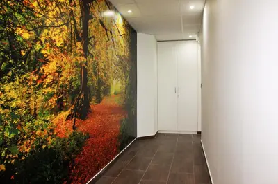 a hallway with a large painting on the wall at Luwiana Suites in Ljubljana