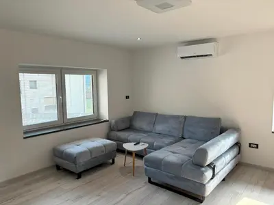 a living room with a couch and a table at Livan Apartment in Tolmin