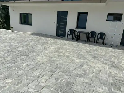 a patio with chairs and a table in a building at Livan Apartment in Tolmin