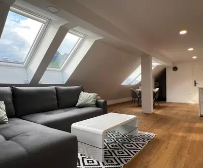 a living room with a couch and a table at Aura Apartments in Žirovnica