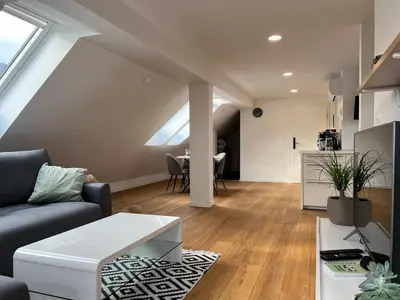 a living room with a couch and a table at Aura Apartments in Žirovnica