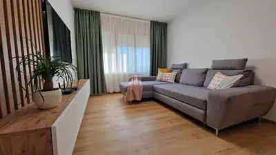a living room with a couch and a table at Apartma Kofol in Kobarid