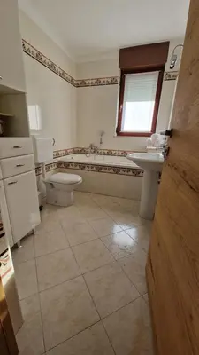 a bathroom with two toilets and a sink and a tub at Apartma Kofol in Kobarid