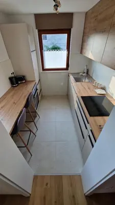 a small kitchen with a sink and a window at Apartma Kofol in Kobarid