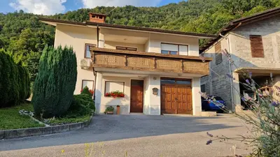 a large house with a balcony on top of it at Apartma Kofol in Kobarid