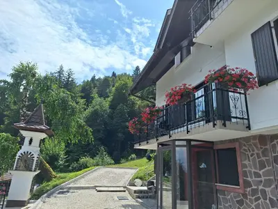 a building with a balcony with flowers on it at Apartma Slovenias in Škofja Loka