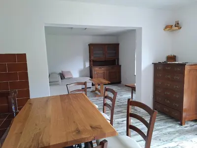 a dining room with a wooden table and chairs at Apartma Slovenias in Škofja Loka