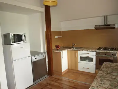 a kitchen with a white refrigerator and a microwave at Apartment VISOTA in Ptuj