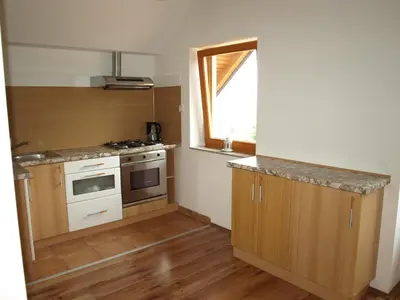 a small kitchen with a stove and a window at Apartment VISOTA in Ptuj