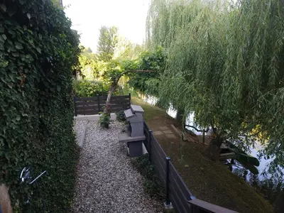 a couple of benches sitting next to a river at Apartment Kostanjevica na Krki in Kostanjevica na Krki