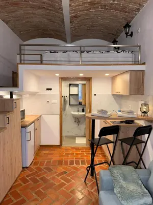 a kitchen with a table and chairs in a room at Zenroom Apartments in Ljubljana