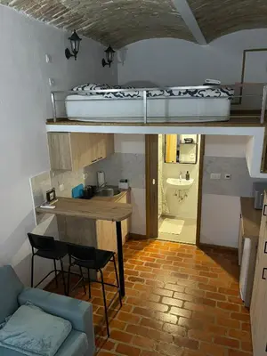 a room with a bed and a table and a couch at Zenroom Apartments in Ljubljana