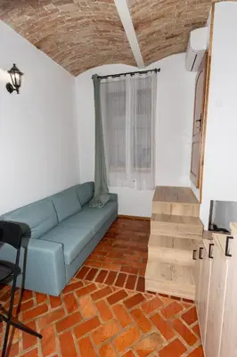a living room with a couch and wooden floors at Zenroom Apartments in Ljubljana