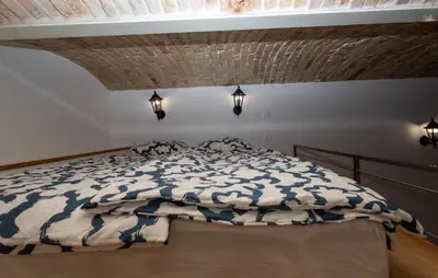 a bedroom with a bed with a blue and white comforter at Zenroom Apartments in Ljubljana