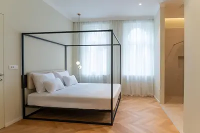 a bed with a glass canopy in a room at Villa Elizabeth - Grand Family Apartment in Slovenj Gradec