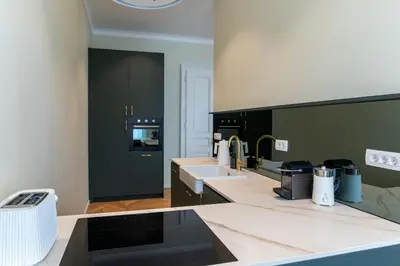 a kitchen with two sinks and a counter top at Villa Elizabeth - Grand Family Apartment in Slovenj Gradec
