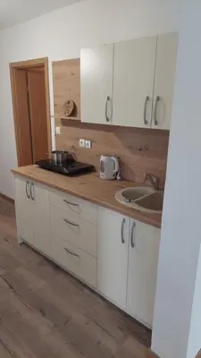 a kitchen with white cabinets and a sink at Bobnarica in Grahovo