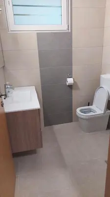 a bathroom with a toilet and a sink and a window at Bobnarica in Grahovo