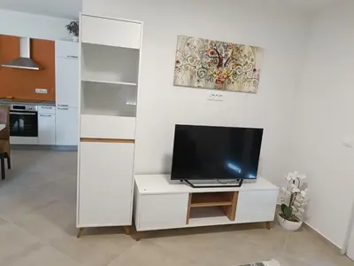 a living room with a tv on a white cabinet at Apartma LANA in Koper